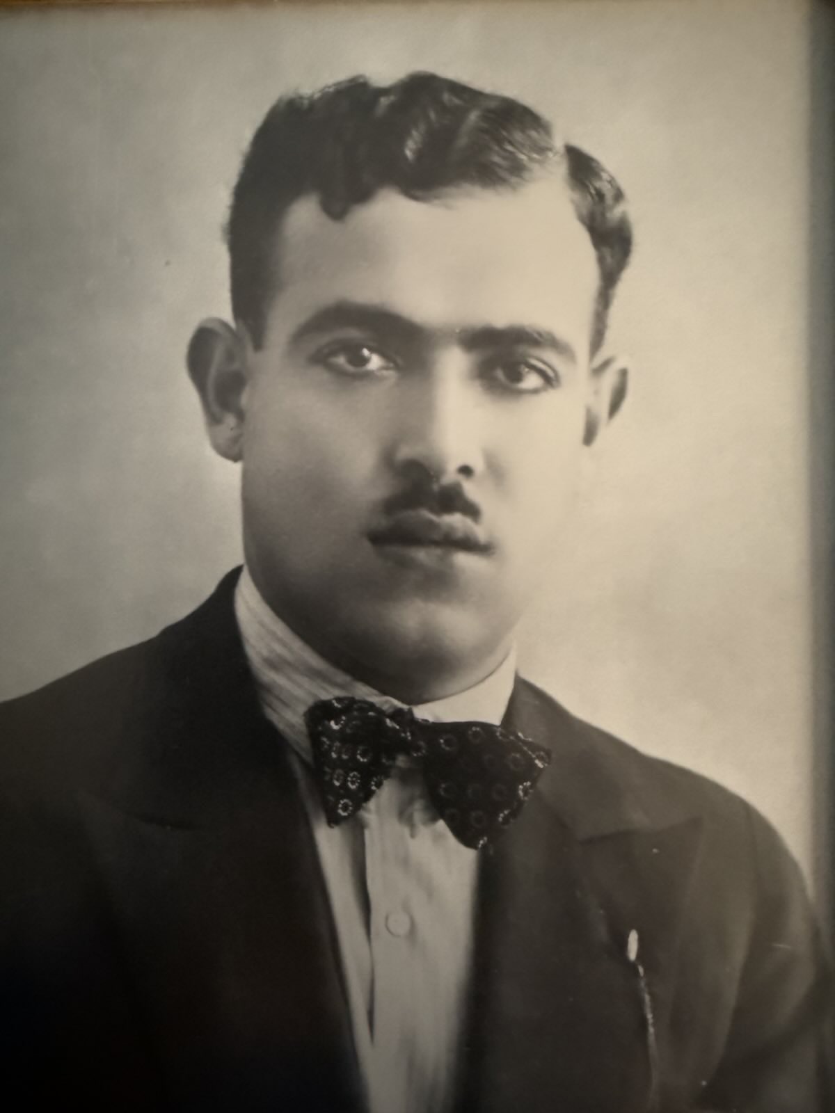 Black-and-white studio portrait of Abdallah Zalatimo, son of Ibrahim, in a suit and bow tie